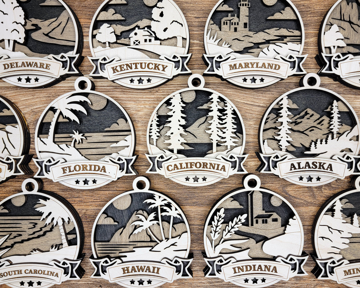 Set of five Discover America state ornaments by The Hollow & Hill Co. LLC, featuring colorful designs representing different states.