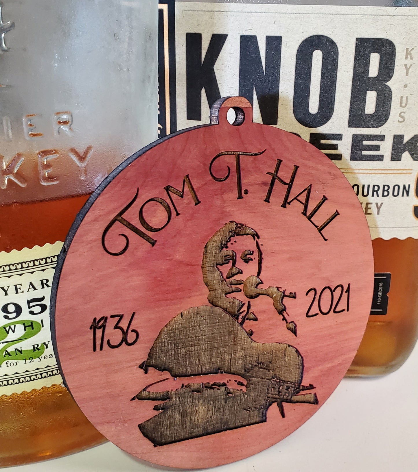 Tom T. Hall ornament by The Hollow & Hill Co. LLC, featuring a detailed decorative ornament with a portrait of the singer-songwriter.