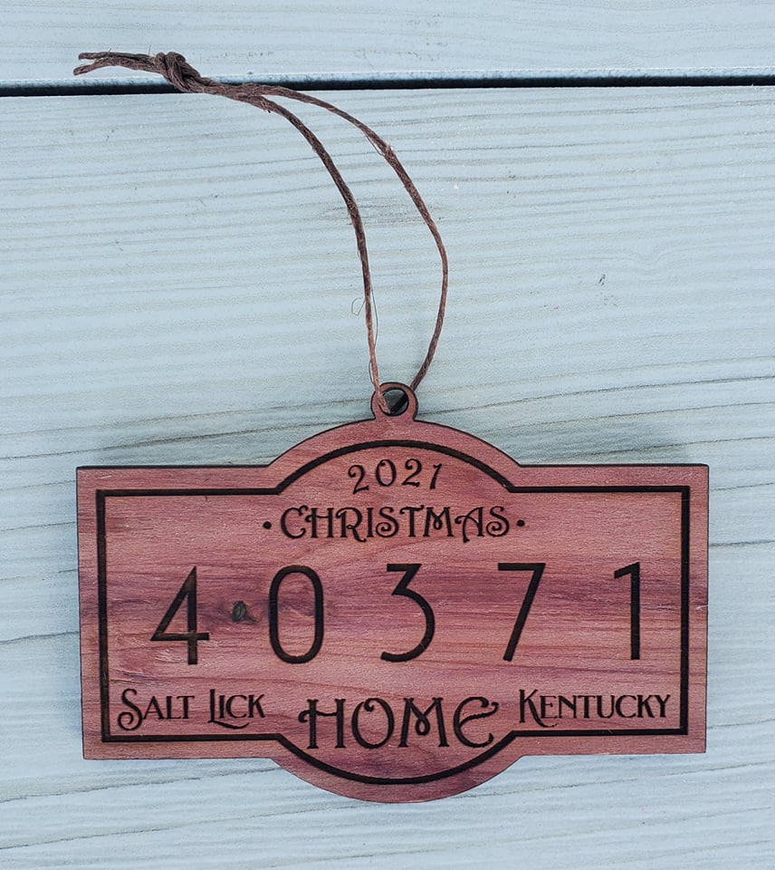 Christmas Zip Code Ornament by The Hollow & Hill Co. LLC hanging on a festive tree with red ribbon and holiday decorations