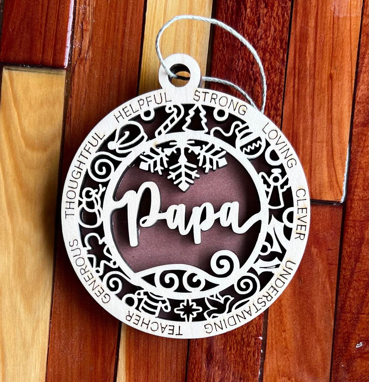 Two-layer wooden ornament from The Hollow & Hill Co. LLC featuring intricate carved designs, ideal for holiday or decorative use.