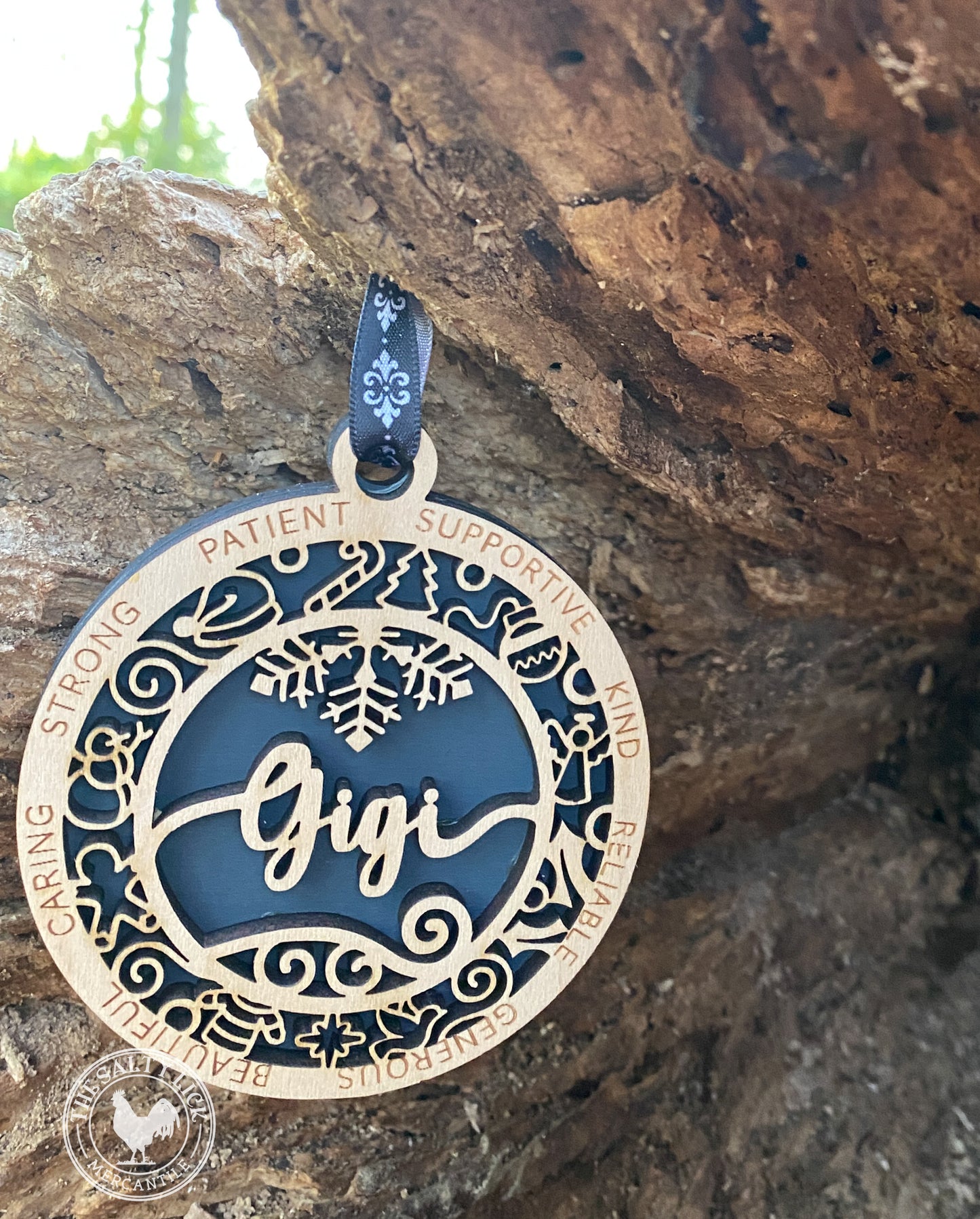 Two-layer wooden ornament from The Hollow & Hill Co. LLC featuring intricate carved designs, suitable for home decor or holiday displays.