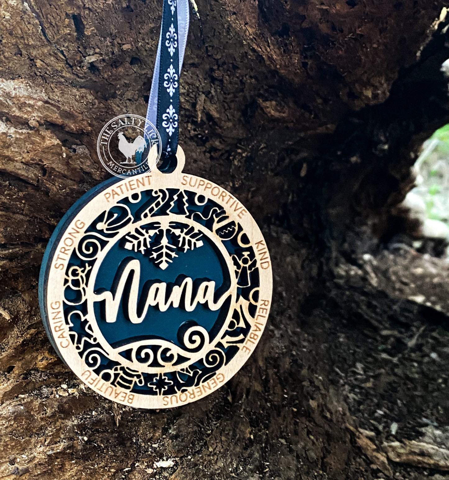 Two-layer wooden ornament from The Hollow & Hill Co. LLC featuring intricate carved details and a natural wood finish.