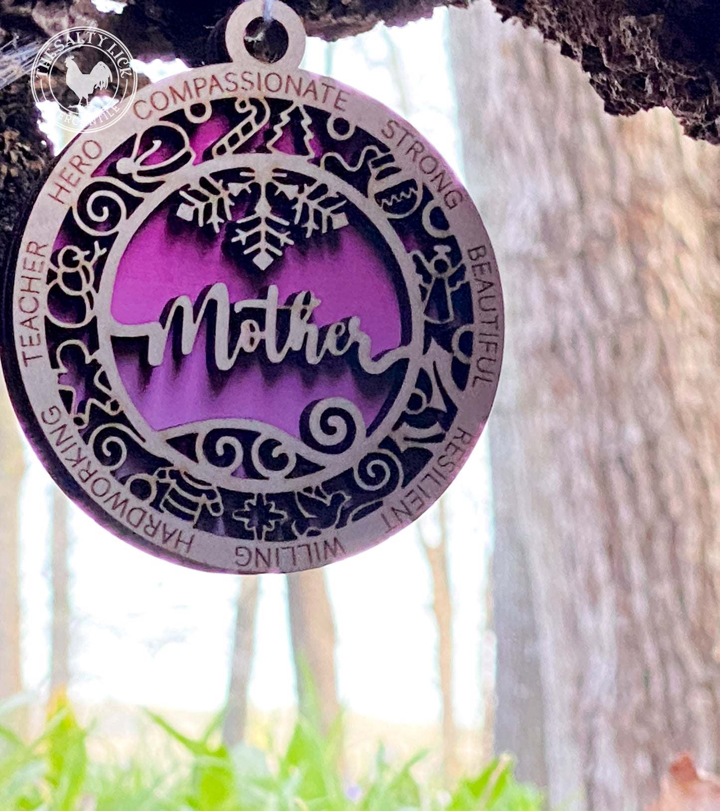 Two-layer wooden ornament featuring a mother design, crafted by The Hollow & Hill Co. LLC, with intricate carved details.
