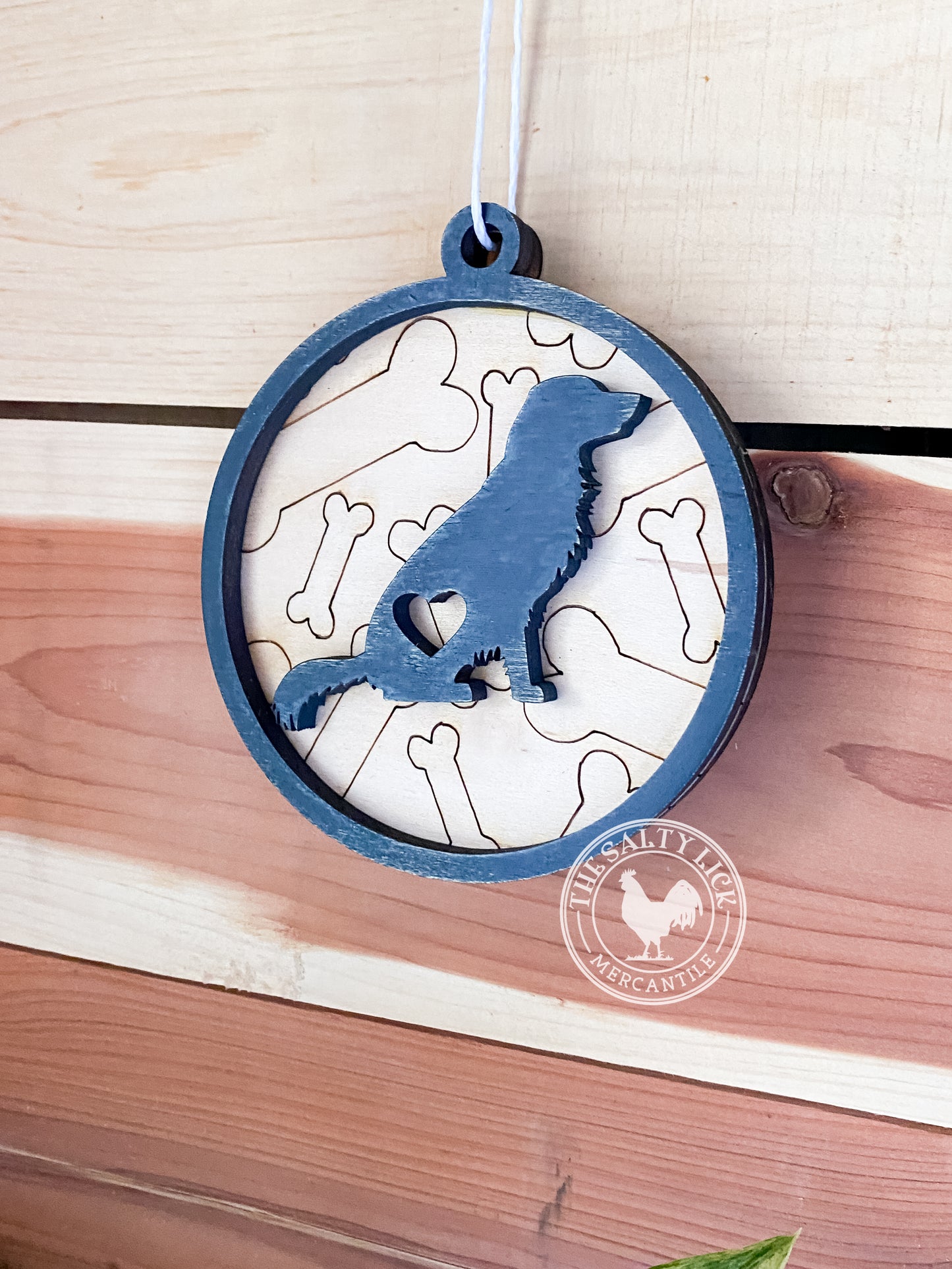 Two 2D dog ornaments featuring multiple breeds, crafted by The Hollow & Hill Co. LLC, displayed on a neutral background.
