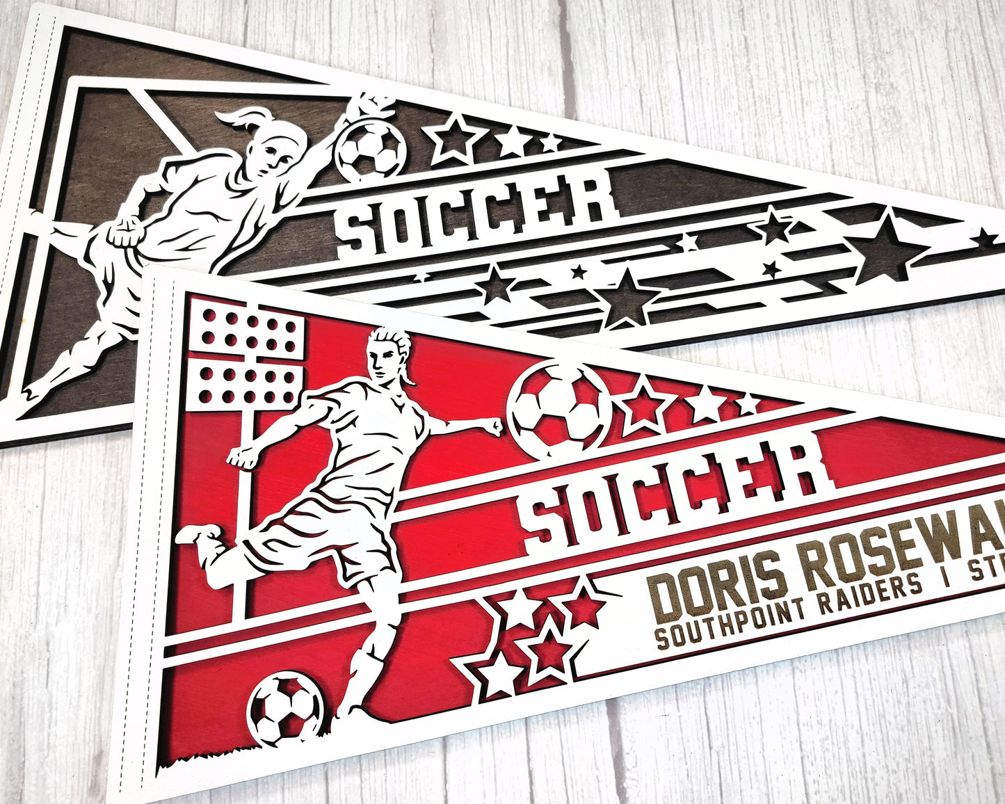 Laser cut personalized soccer pennant sports sign by The Hollow & Hill Co. LLC, featuring a detailed soccer design in male and female versions.