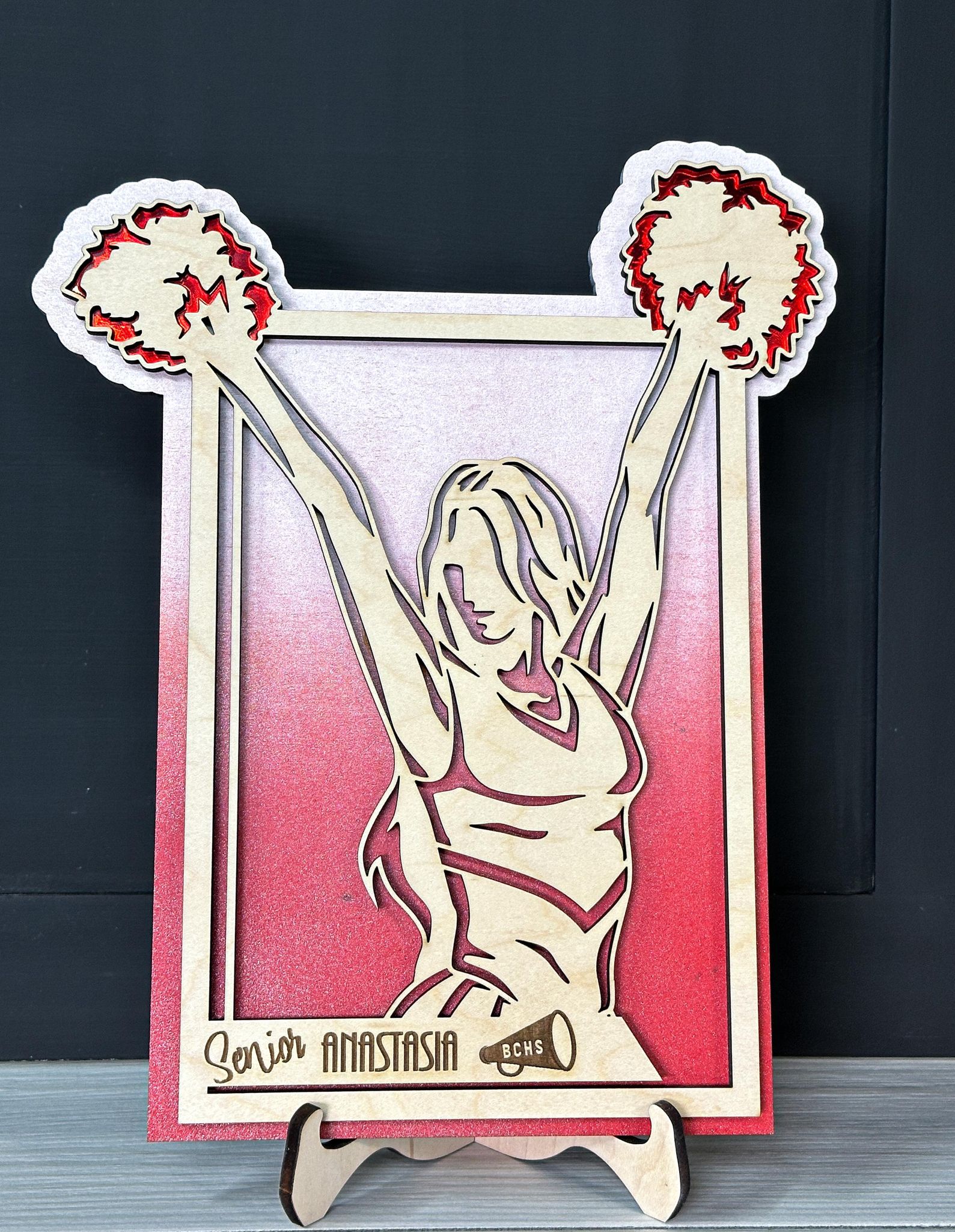Personalized cheerleader plaque with sports-themed design from The Hollow & Hill Co. LLC, featuring custom text on a decorative sign.